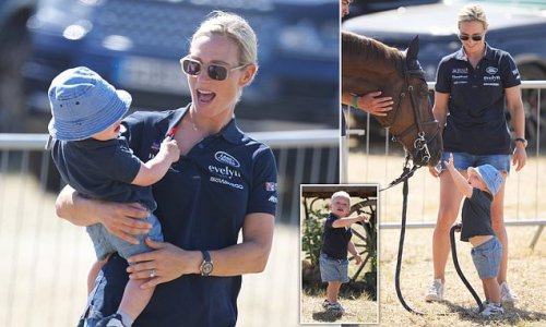Taking the reins! Zara Tindall beams as her one-year-old son Lucas pets a horse during their day out at Festival of British Eventing at Gatcombe Park