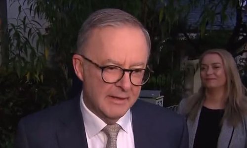 Anthony Norman Albanese is officially sworn in as Prime Minister of Australia as his son Nathan, 21, can't stop smiling and girlfriend Jodie watches on