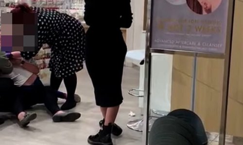 Girl screams 'get off' as she is held down while her ears are pierced