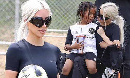 Not your average soccer mom! Kim Kardashian forgoes bra in backless top to cheer on her son Saint, six, from the sidelines