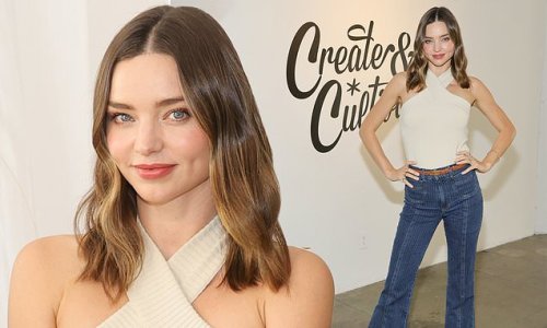 Supermodel Miranda Kerr looks elegant in a halter-neck top and flared jeans as she attends the Wellness Means Business summit in LA