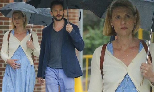 Pregnant Claire Danes shows off her growing baby bump in blue dress as she enjoys a rainy walk with husband Hugh Dancy in New York City