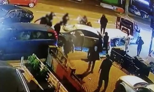 Shocking moment gang use flatbed truck to slam into vehicle before using baseball bats to smash through the windows and attack occupants in terrifying ambush