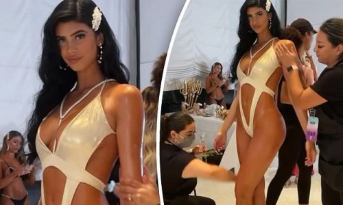 Lucciana Beynon is lathered with baby oil backstage at Miami Swim Week
