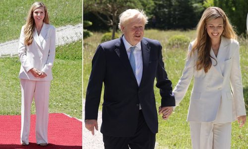She means business! Carrie Johnson looks sharp in a smart white blazer and wide-leg trouser combo as she joins husband Boris at the G7 summit in Germany