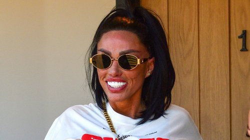 Katie Price, 46, shows off her gleaming white teeth and tattooed midriff as she leaves a tanning salon in Brighton after shocking fans with new look