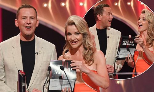 Helen Skelton puts on a busty display in a plunging coral gown as she takes to the stage to present a prize at the British Soap Awards