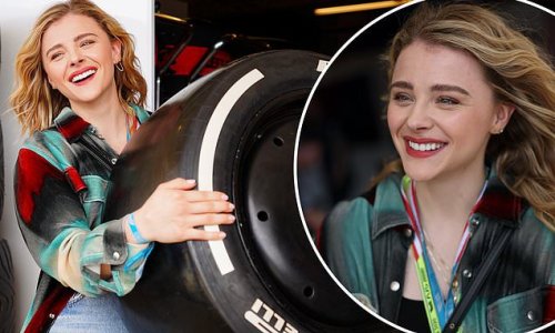 Chloe Grace Moretz shows off her strength as she lifts a wheel outside