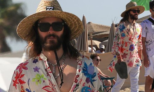 Jared Leto, 50, exhibits his flamboyant sense of style in a plunging floral shirt and cowboy hat as he strolls barefoot along the beach in St Tropez