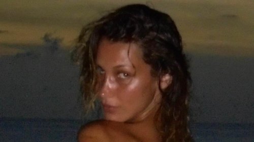 Bella Hadid is breathtaking as she showcases her stunning frame in a fitted cutout minidress in tropical throwback photos