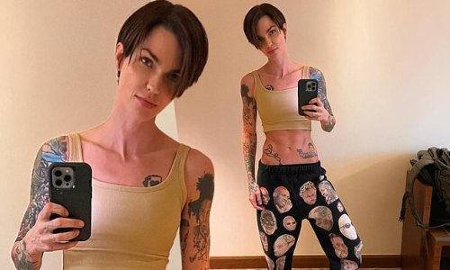 Abs-olutely fabulous! Ruby Rose shows off her tattooed and toned stomach as she poses in hareem pants covered in pictures of Dennis Rodman and a pair of Dior sneakers