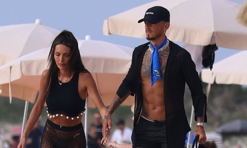 Ben White and wife Milly Adams hit the beach in Ibiza as Arsenal star soaks up the sun on his honeymoon... as newly-wed couple show off matching outfits in Spain