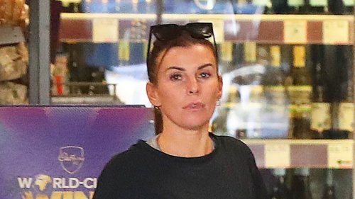 Coleen Rooney cuts a casual figure in a gym top and skintight leggings as she runs errands in her £120k Land Rover