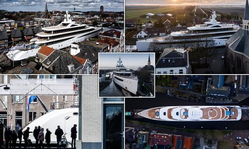 Pictured: New superyacht is carefully manoeuvred along narrow canals