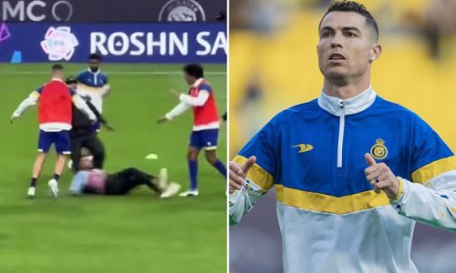 Cristiano Ronaldo narrowly avoids injury as he is almost TAKEN OUT by  overzealous pitch invader who forced Al-Nassr star to take evasive action  as he slipped dangerously close to his feet |