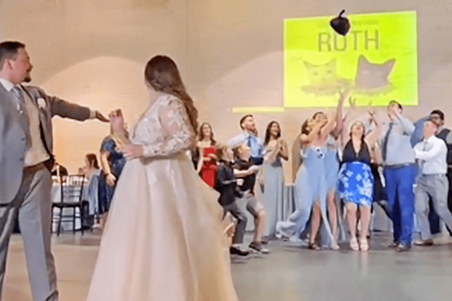 Watch This Bridesmaid Go All Out To Prove Why The Cat Toss Is the Best Wedding Tradition