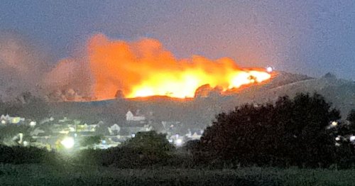 Massive fire engulfs hill as flames climb hundreds of feet in the air