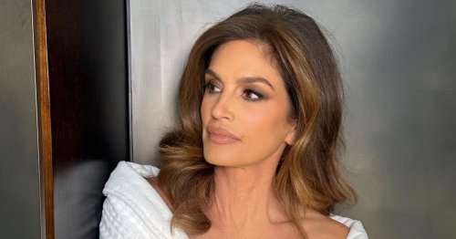 Cindy Crawford poses in nothing but a robe as she gets ready to party in Vegas