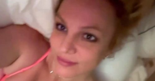 Britney Spears strips to underwear as she rolls around in bed for racy new video