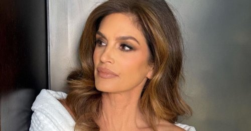 Cindy Crawford strips off as she flashes supermodel legs from under open jacket