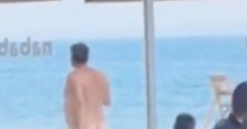 Benidorm tourists howl with laughter as naked man strolls through crowded beach