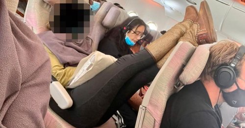 Passenger fumes as person next to him turns plane seat into bed and puts feet up