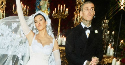 Travis Barker rips off Kourtney Kardashian's garter with his teeth in risqué wedding pics
