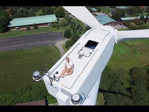 Man Sunbathing On Top Of A Wind Turbine Is Caught By A Drone