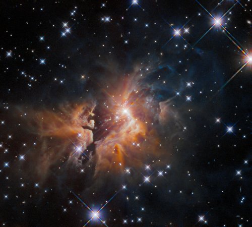 Bright young star shoots out strange fan of material in Hubble image