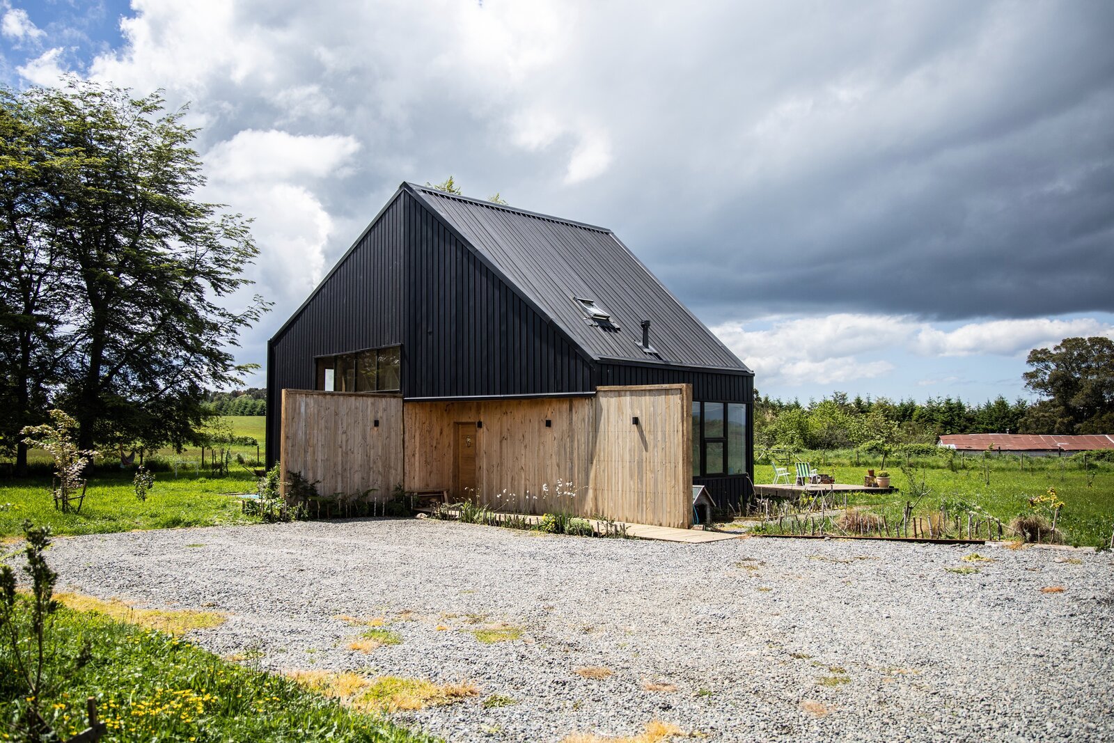 Lots of Windows and a Sunroom Suffuse This Black Chilean Cabin With Light