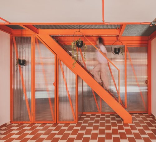 A Framework of Orange and Green Steel Reorganizes a Madrid Home for a Family of Four