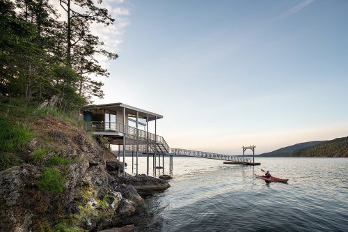 A Streamlined Boathouse Perches Above the Water in the San Juan Islands