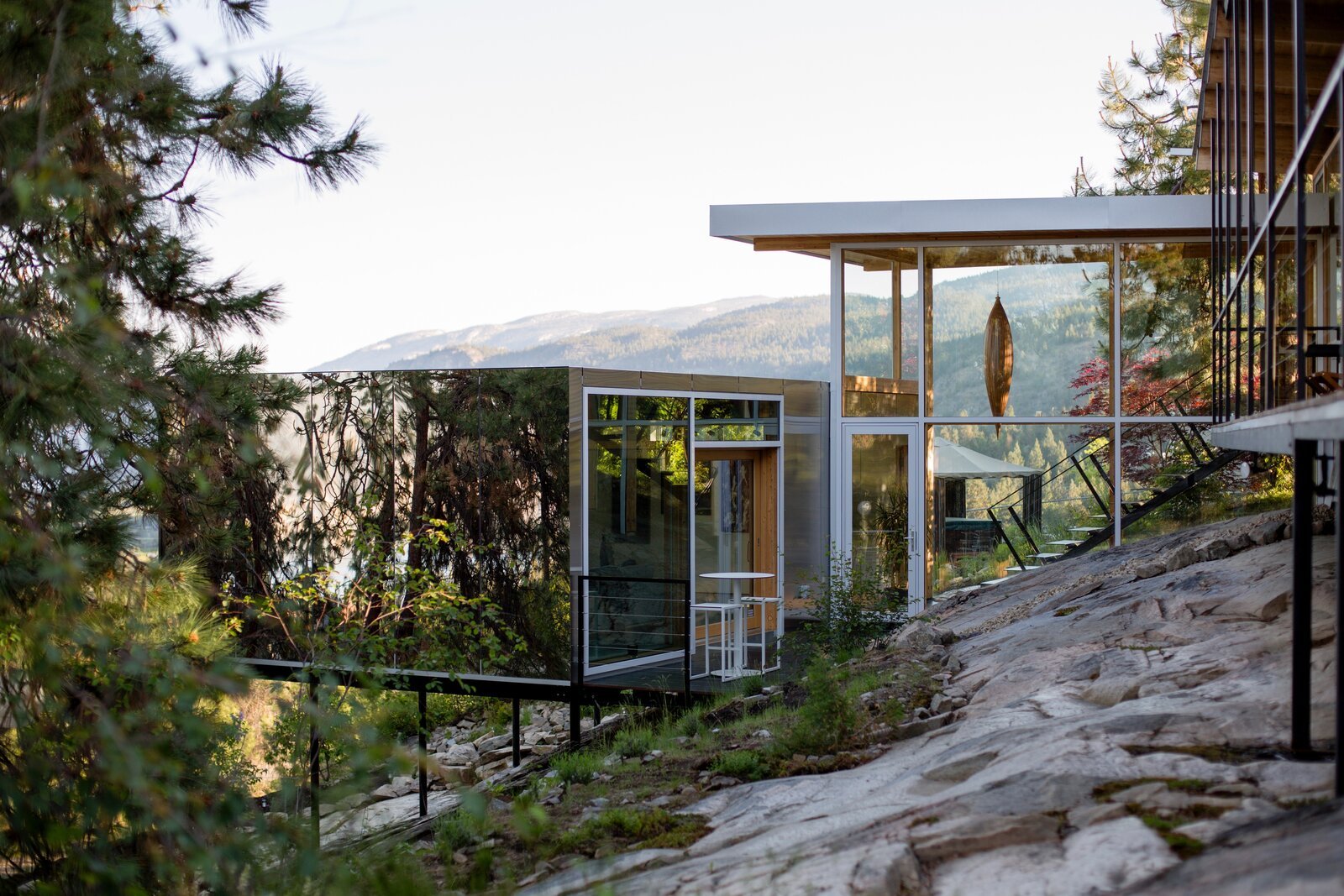 A Mirrored Addition Melds With Its Rocky Site in British Columbia