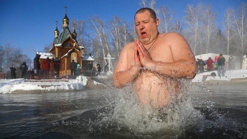 In pictures: Russian Christians plunge into icy water to mark Epiphany