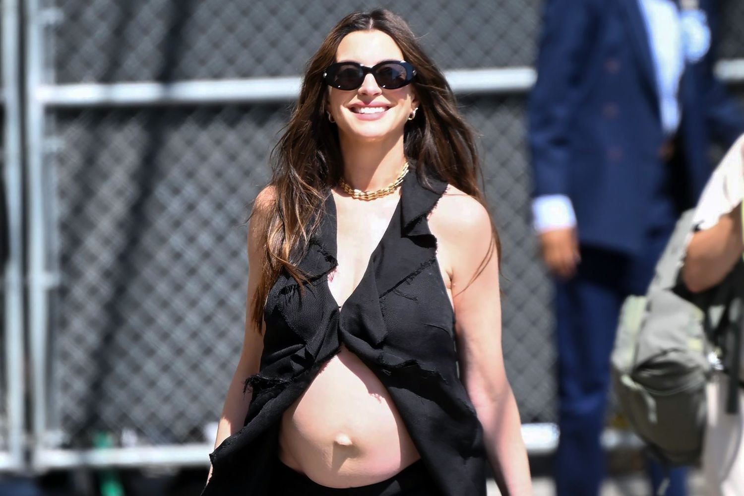 Anne Hathaway bares baby bump — again! — in frilly top after addressing wild fake pregnancy rumors