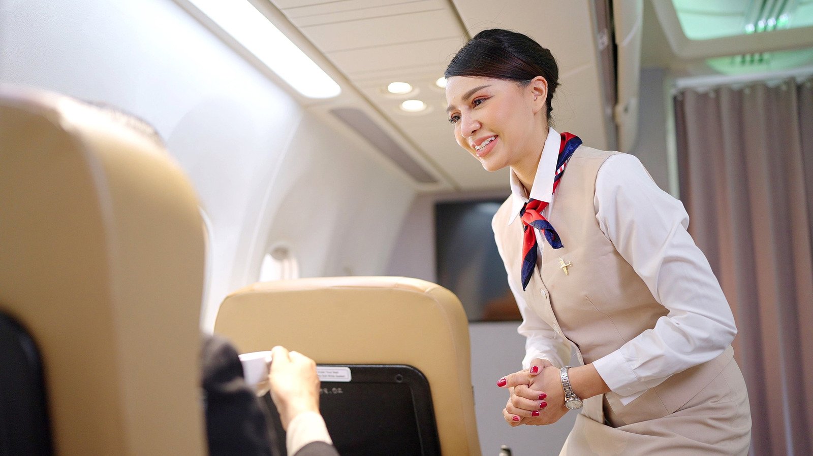 1 Thing Flight Attendants Aren't Allowed To Do That Nearly Every Passenger Does - cover