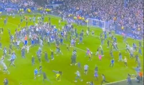 Sheffield Wednesday linesman sent flying by fan as pitch invasion turns