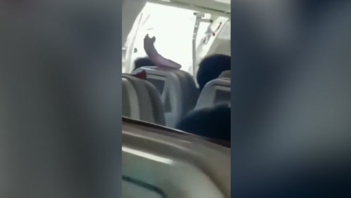 Terrifying moment plane door opens mid-air after ‘passenger pulls emergency exit lever’