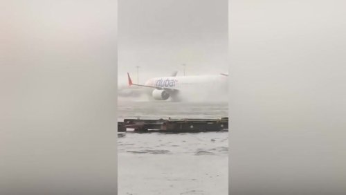 Plane battles through floods at Dubai airport as heavy rain causes cancelled flights