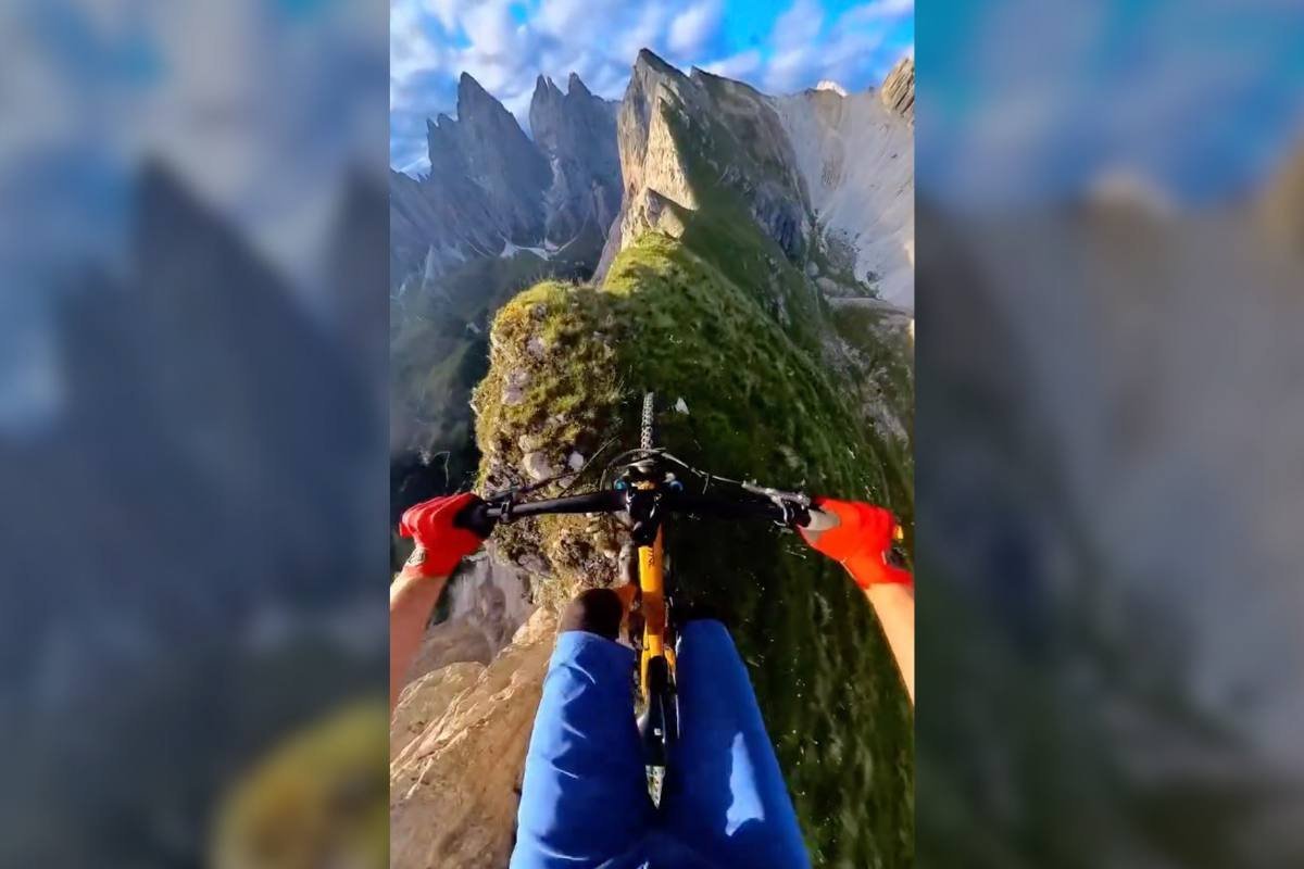 Try not to panic while you watch this mountain biker ride a barely-there ridge