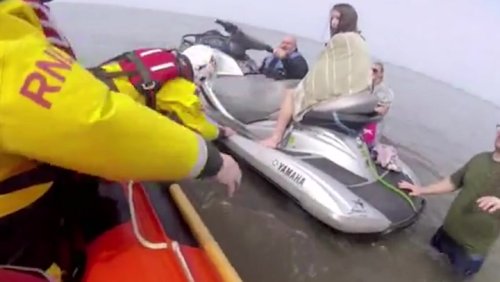 Dog walkers cut off by tide saved by passerby on jet-ski