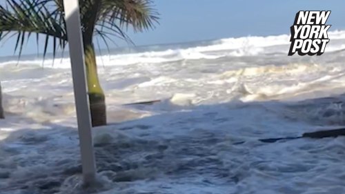 Biblical wave crashes into beachfront restaurant