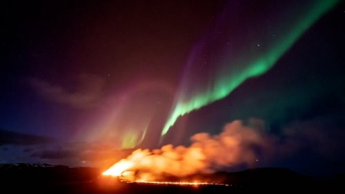 Northern Lights shine over Iceland’s erupting volcano in stunning timelapse footage