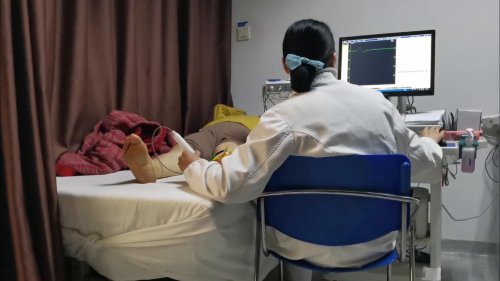 A doctor gives a neuromyogram examination to a patient at a hospital in Yichang, China
