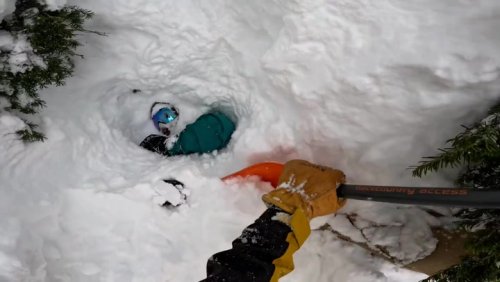 Moment snowboarder rescued by passing skier after being buried upside down