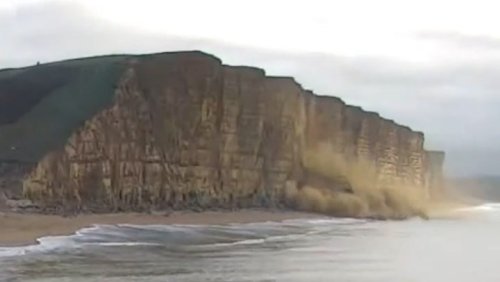 Watch moment massive chunk of West Bay cliff falls onto beach