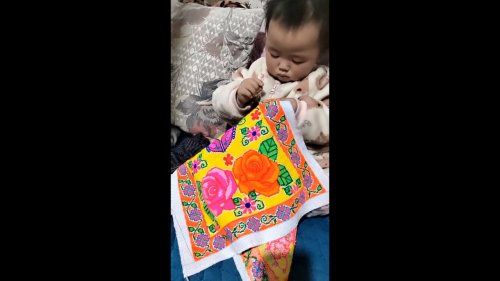 Little girl shows strong interests in learning embroidering in Zunyi, China