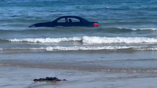 ‘A disgrace’: BMW driver slammed after £100,000 car is washed out to sea