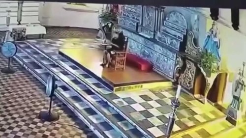 Philippines: Worshipper rides into church on a MOTORBIKE to reach altar and pray