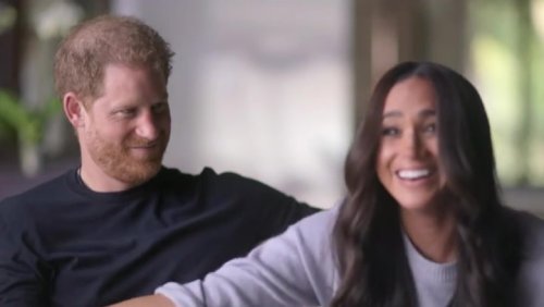 Harry appears unimpressed as Meghan mocks curtseying to Queen